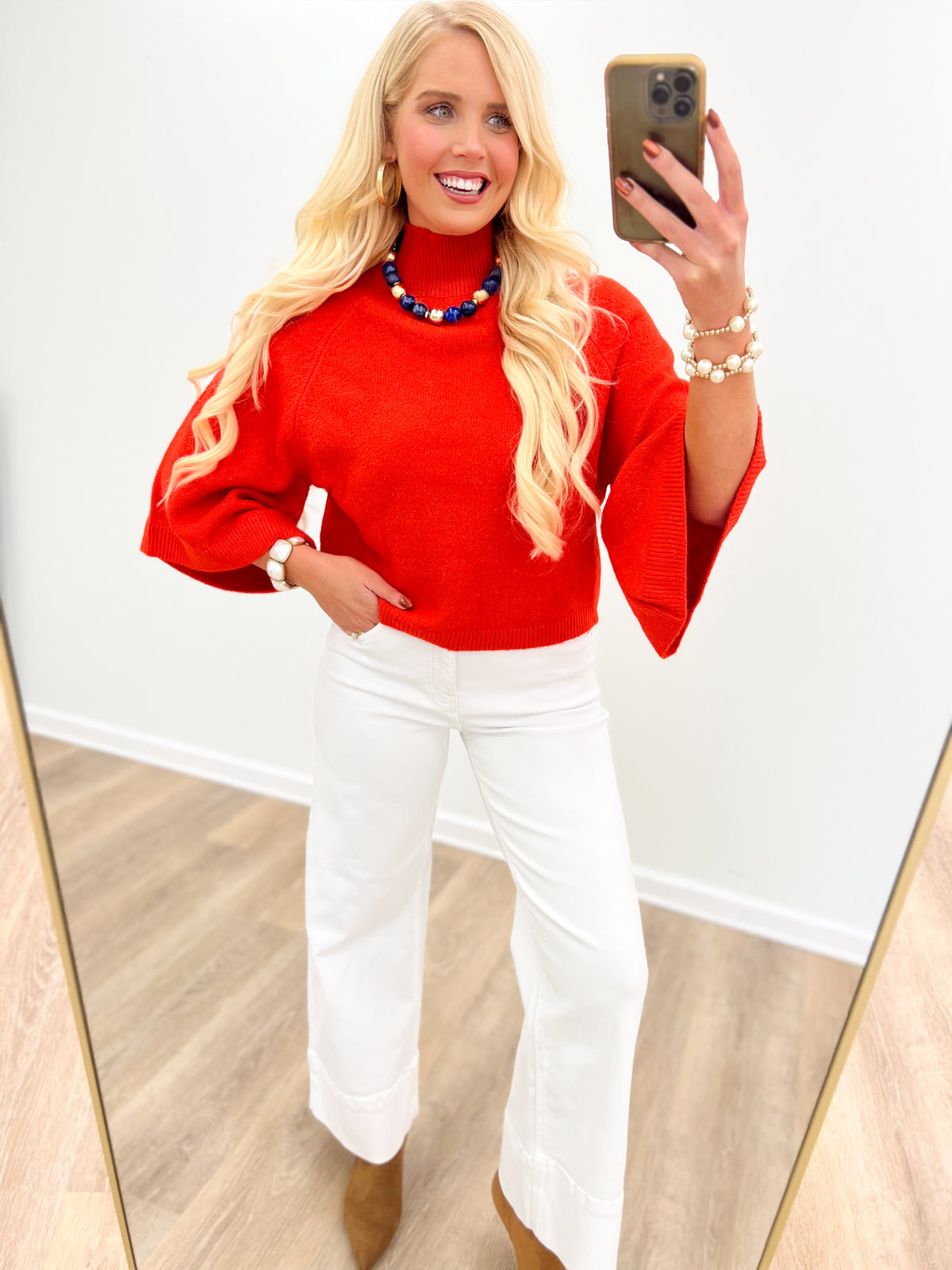 Red mock neck sweater with wide sleeves, featuring a clean crew neckline
