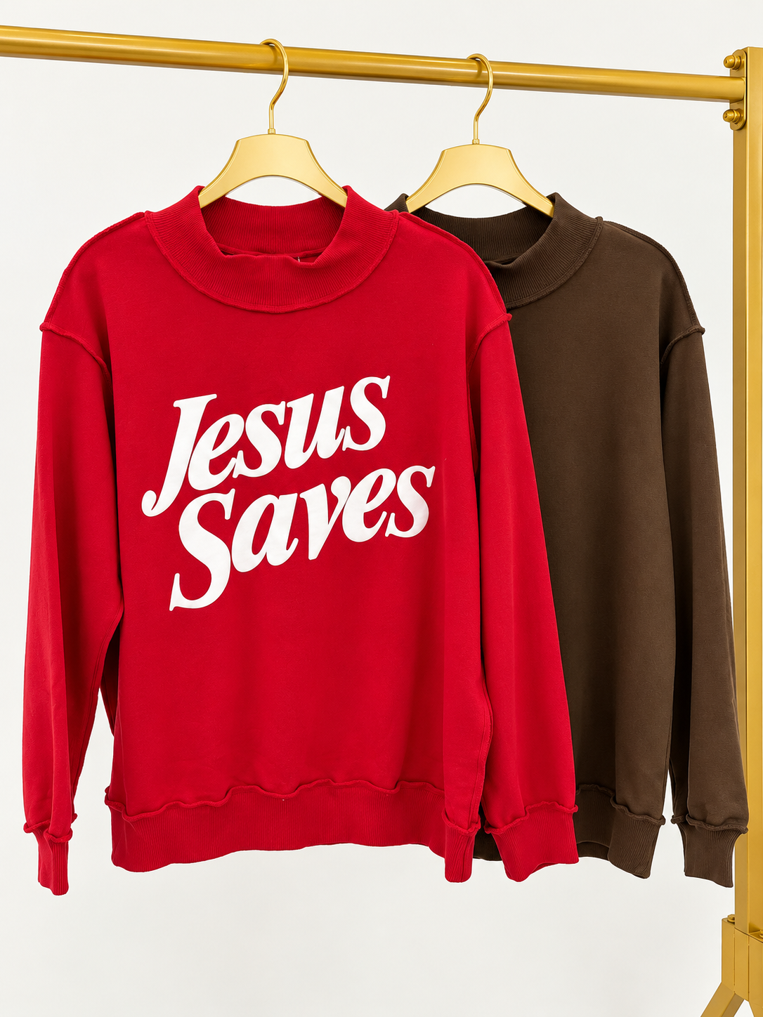 Red and dark brown mock neck sweatshirts with “Jesus Saves” prints