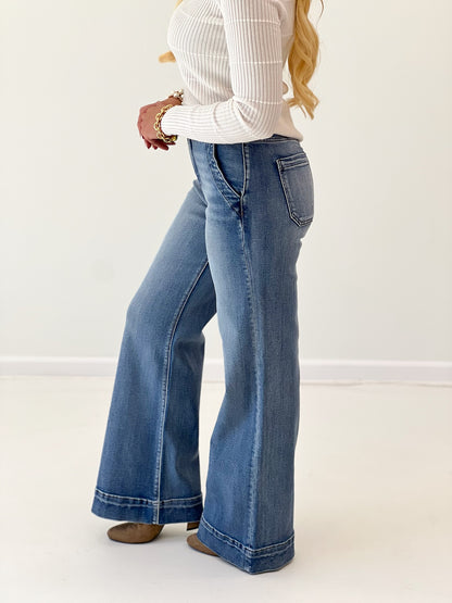 Medium-blue high-rise wide flare jeans with wide hem, button fly, side pockets
