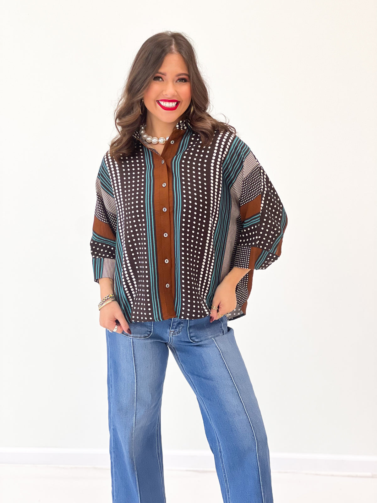 Brown mixed-print stripe shirt close-up: collarless? button front, dotted and striped pattern