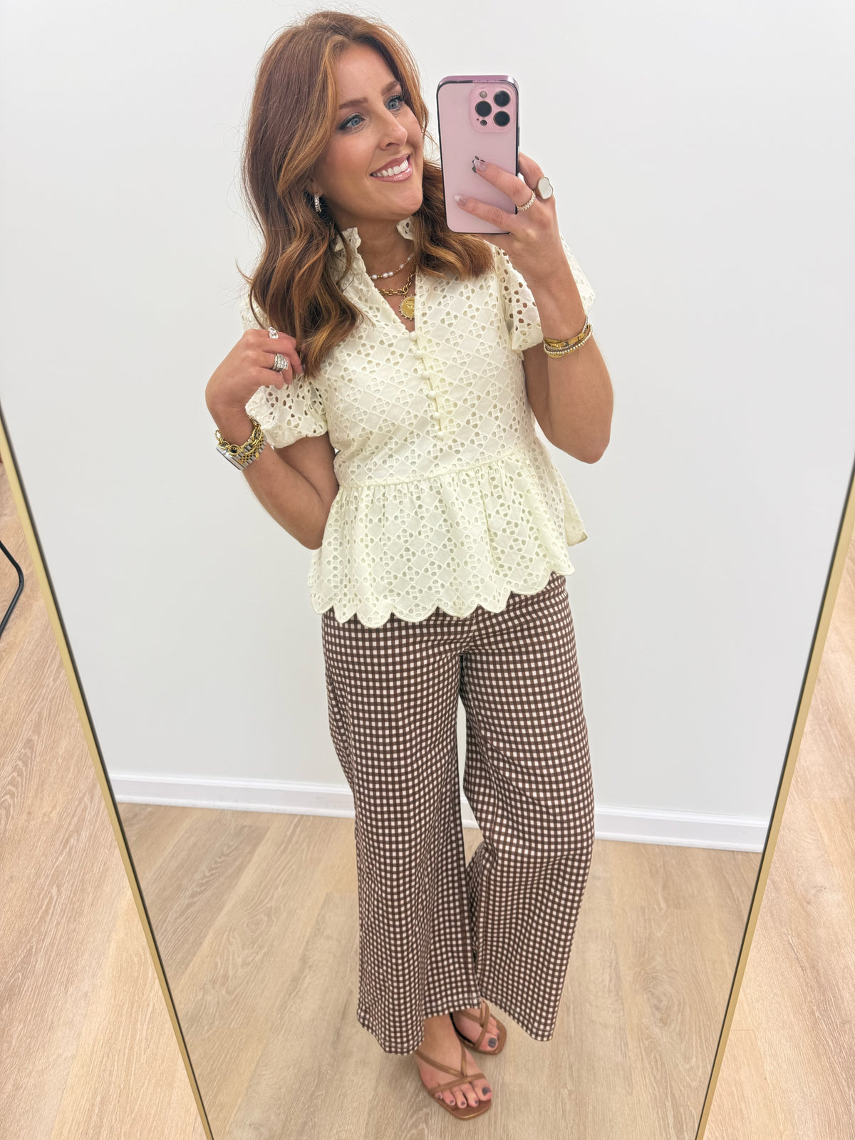 Cream eyelet ruffle-neck top with scalloped peplum hem and short puff sleeves