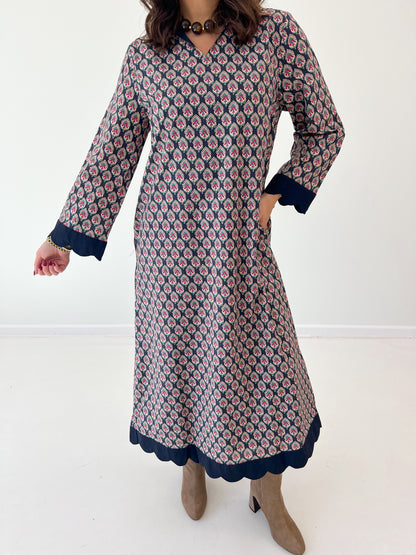 Navy floral V-neck maxi dress with long sleeves and scalloped hem trim