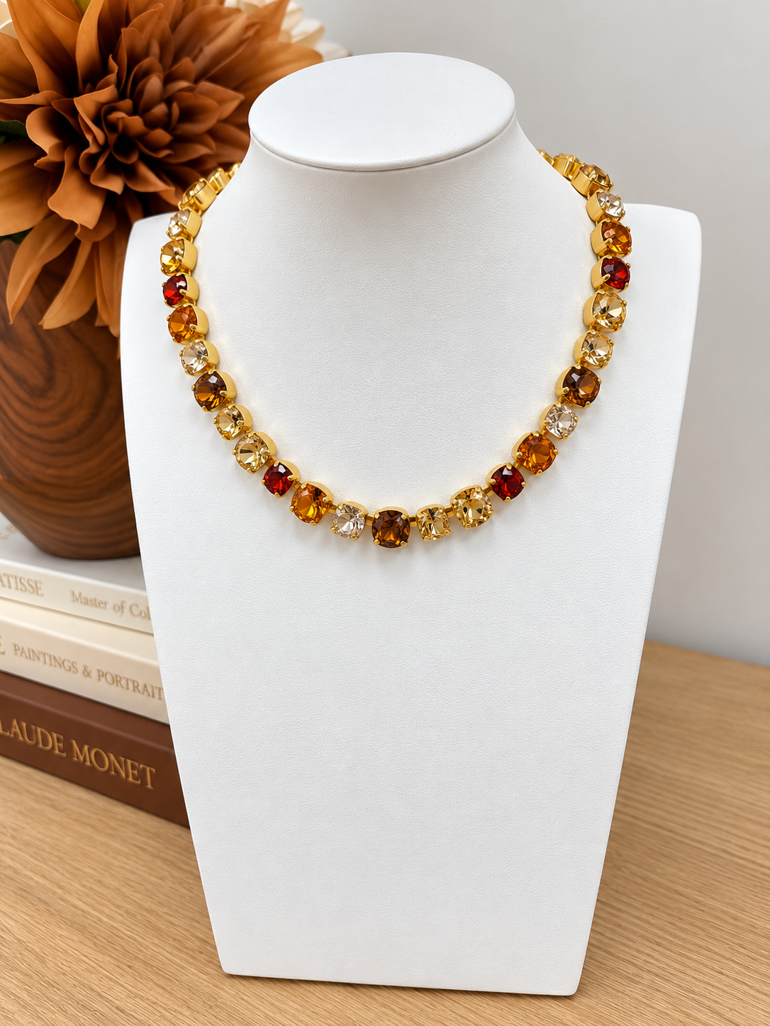 Gold-tone gemstone necklace with amber, red, and clear round beads