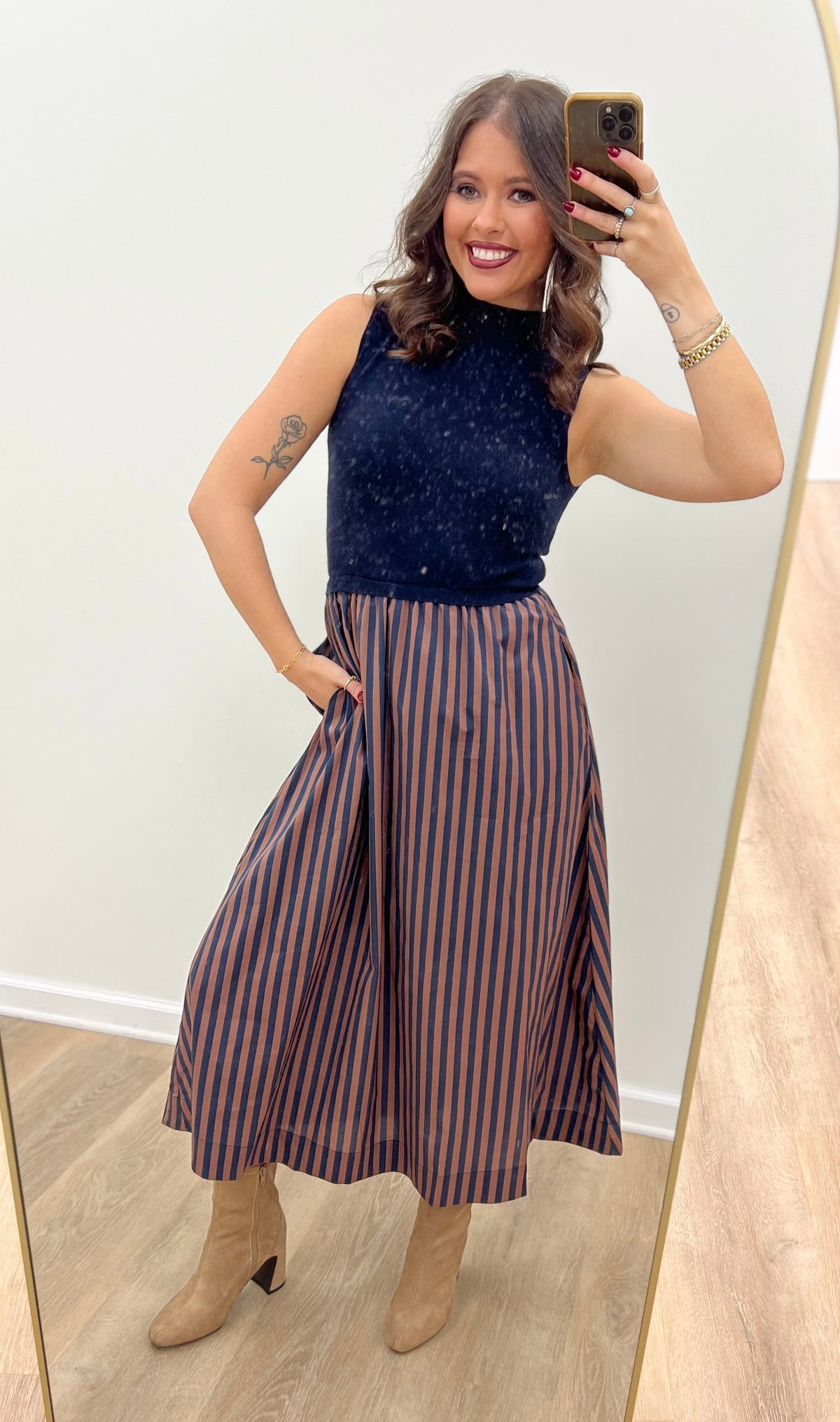 Navy sleeveless midi dress with vertical striped skirt and fitted bodice