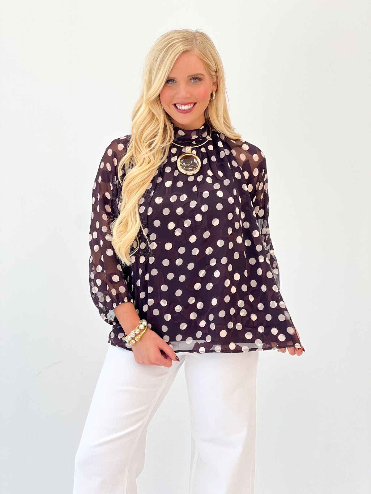 Black polka dot high-neck blouse with long balloon sleeves and keyhole front