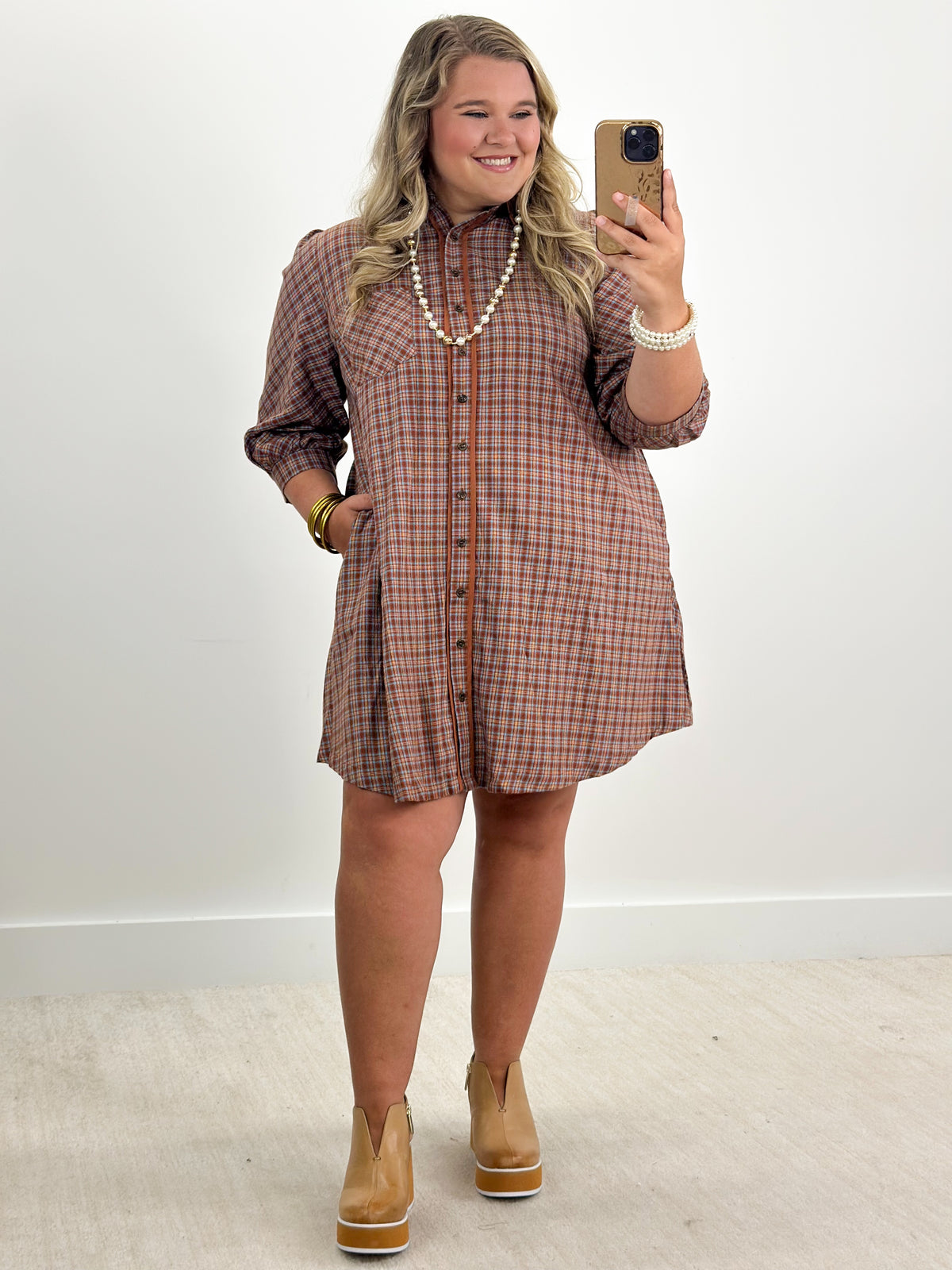 Rust plaid button-down long-sleeve dress with collar and front buttons, above-knee length
