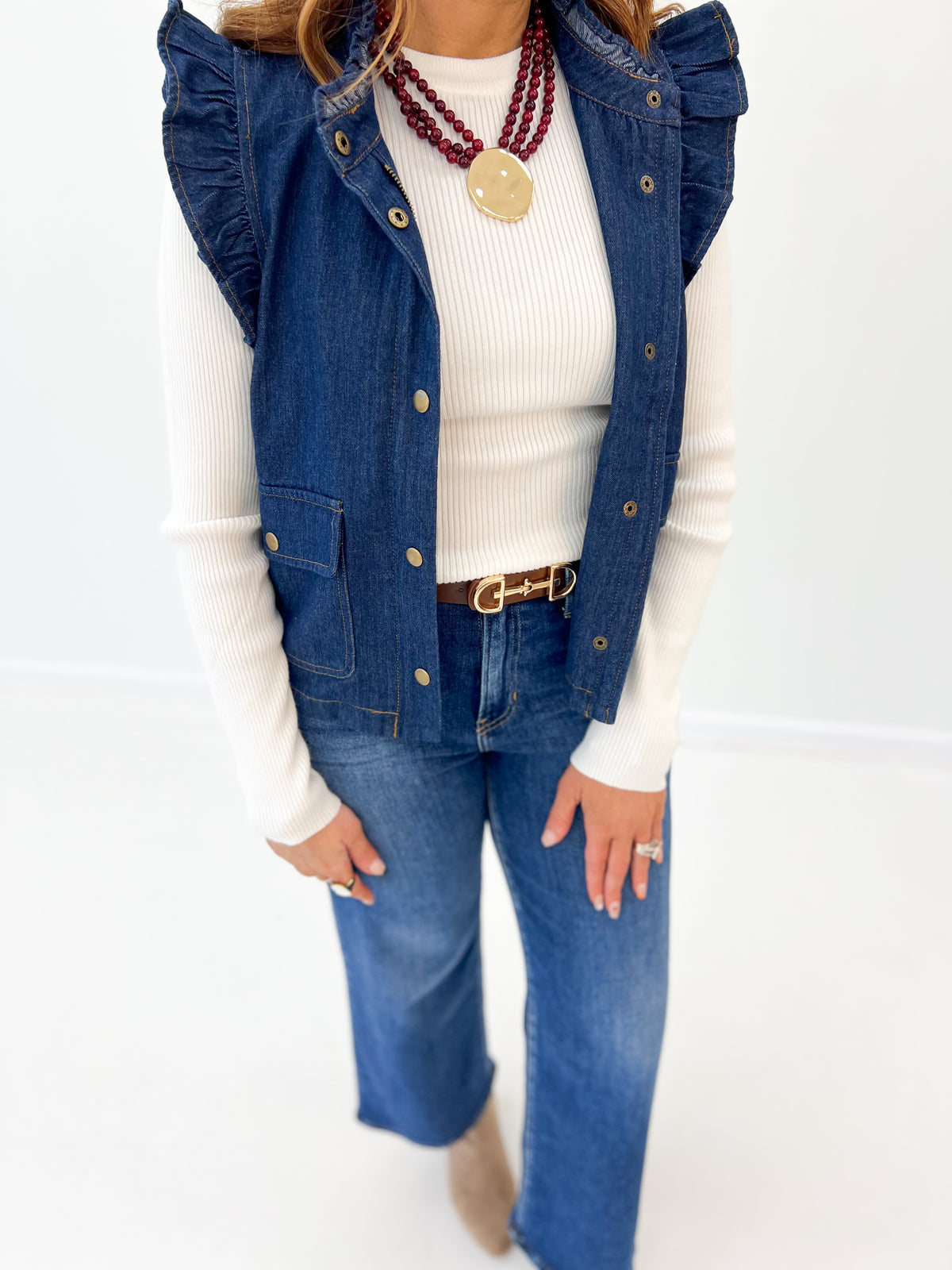 Close-up denim flutter sleeve vest with button front and buttoned flap pockets
