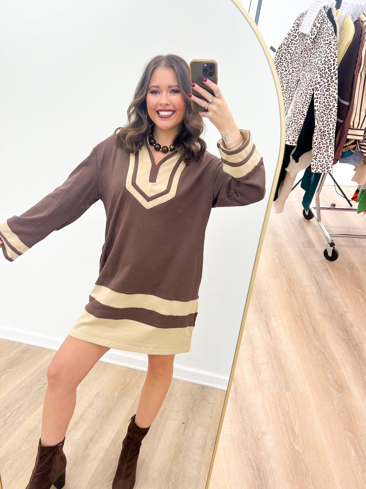 Brown V-neck color-block sweatshirt dress with cream stripe at hem and striped cuffs