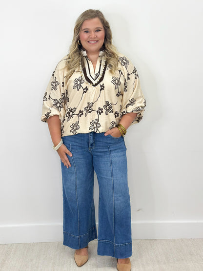Ecru floral collared V-neck blouse with black flower print, short sleeves