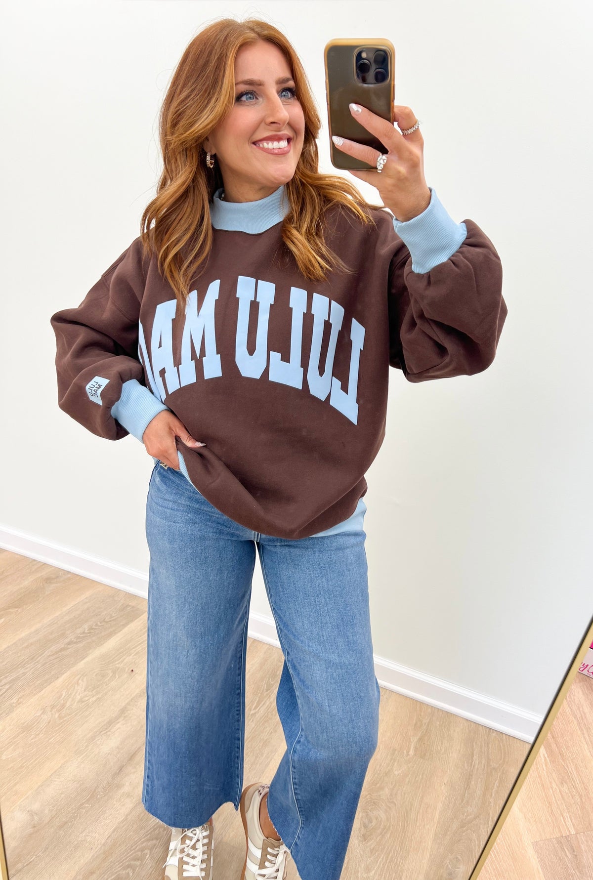 LuLu Mac brown sweatshirt with white “AM LULU MAC” graphic and light blue mock neck