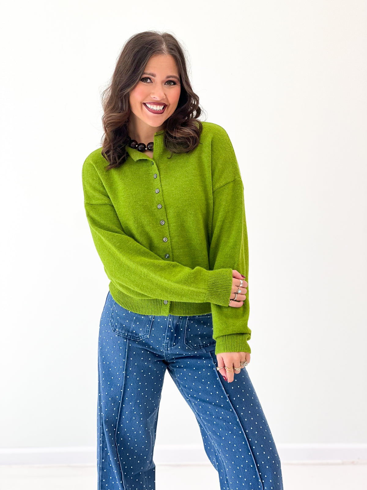 Pea green fold-over neck sweater with buttoned front placket detail