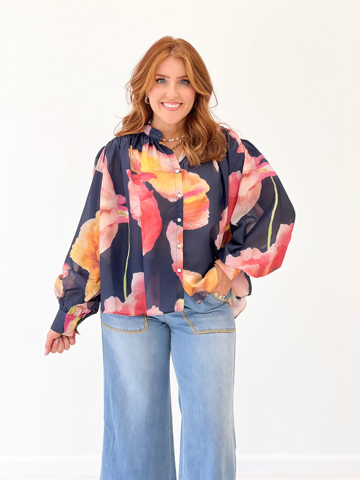 Navy floral print blouse with full sleeves and button front, bright pink and orange accents