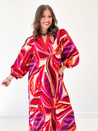 Red boho midi dress close view, V-neck and voluminous puff sleeves, abstract print