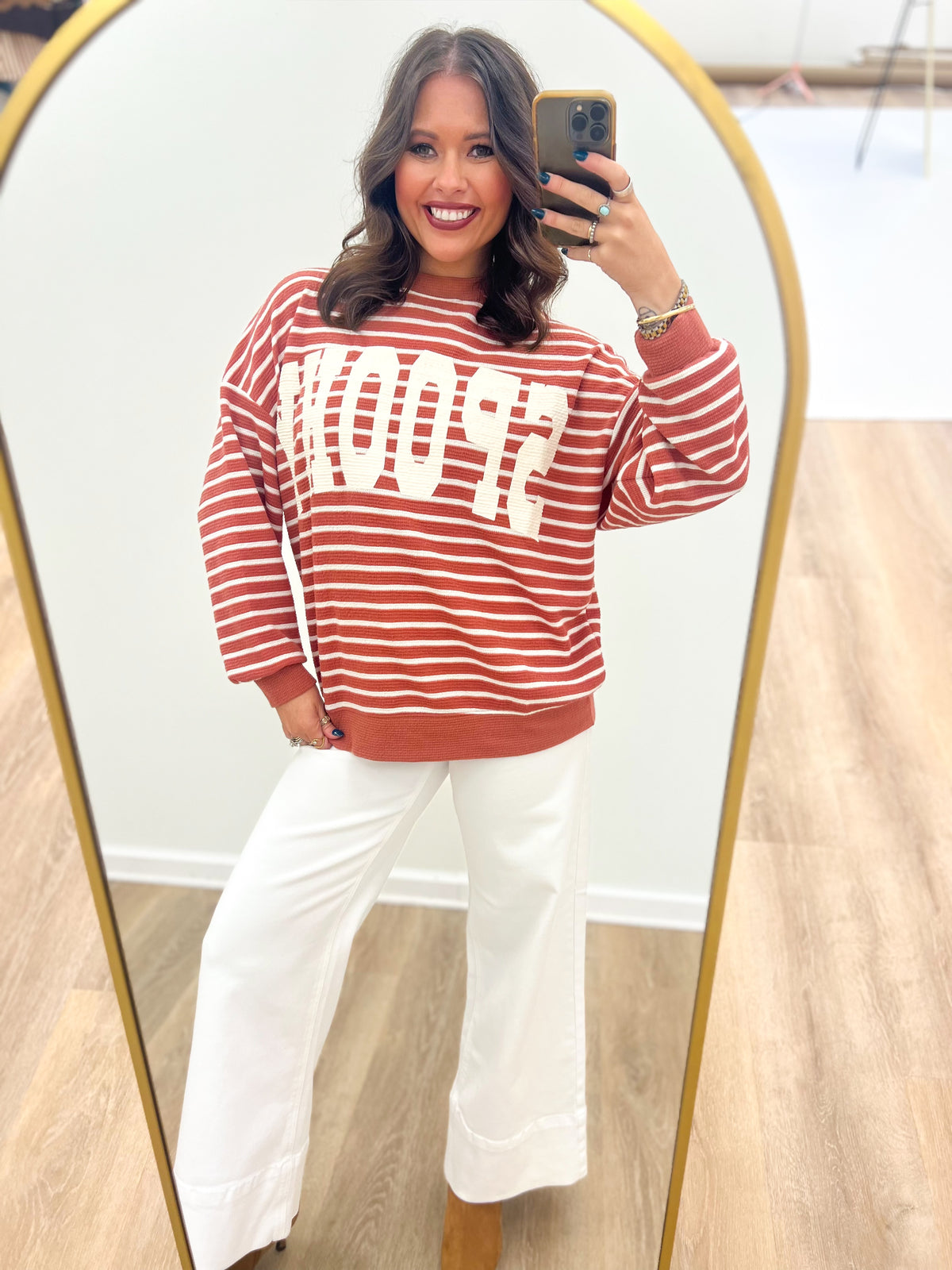 Rust red and white striped knit top with spooky graphic, ribbed hem and cuffs