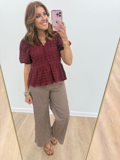 Burgundy eyelet ruffle-neck top with scalloped peplum hem and short puff sleeves