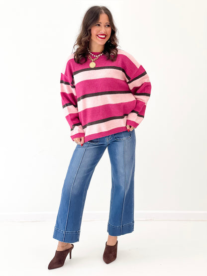Magenta striped knit sweater top with black and light pink bands, relaxed fit, crew neck