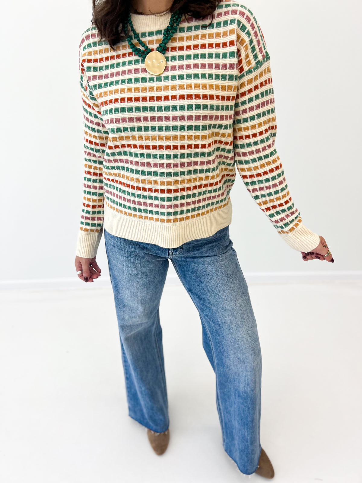 Multi-color striped sweater with ribbed cream hem and crew neck, long sleeves
