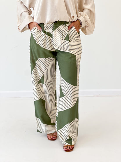 Olive green wide-leg pants with patchwork stripe print and elastic waist