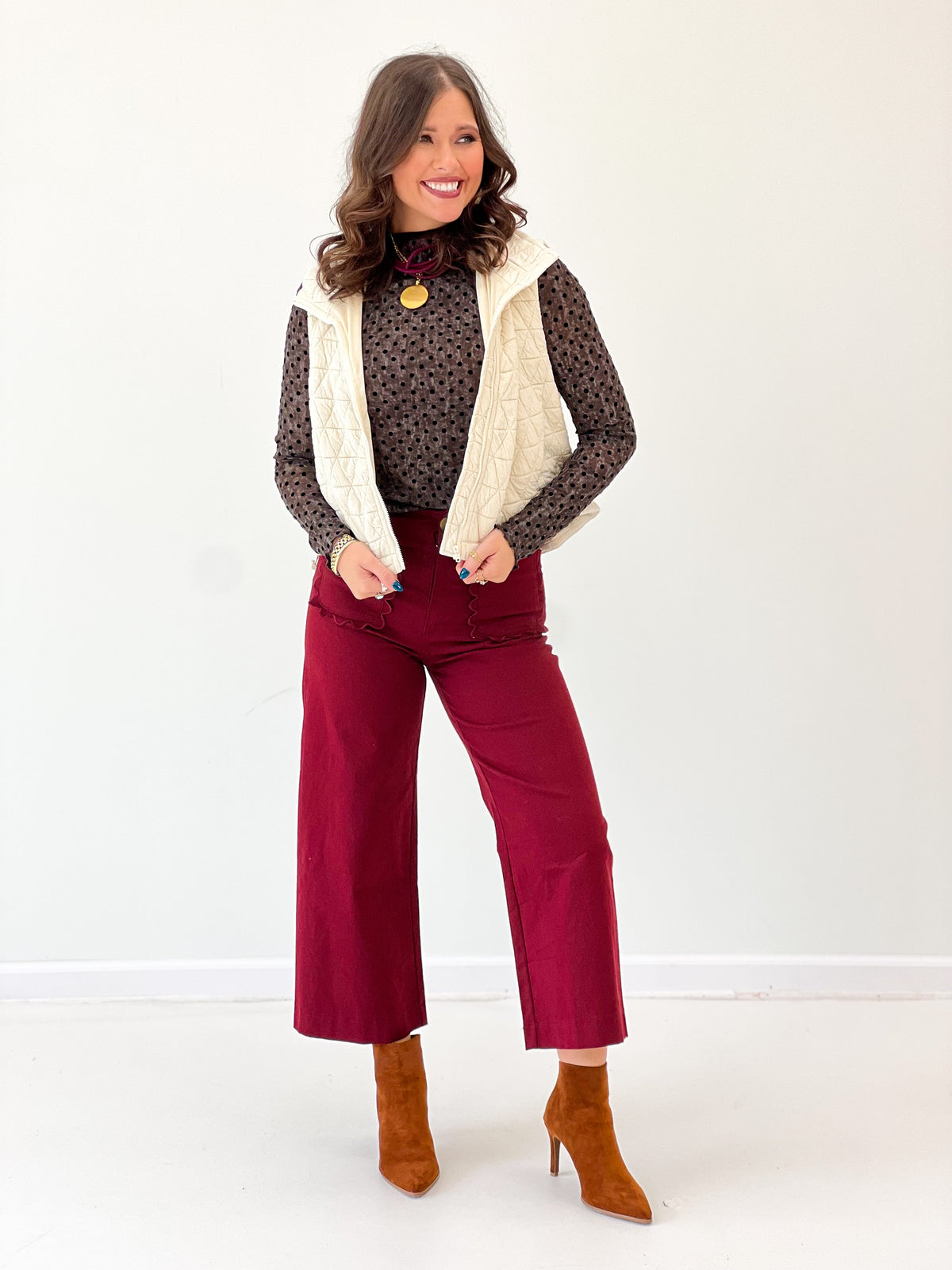 Ivory quilted sleeveless vest with stand collar and diamond pattern, open front