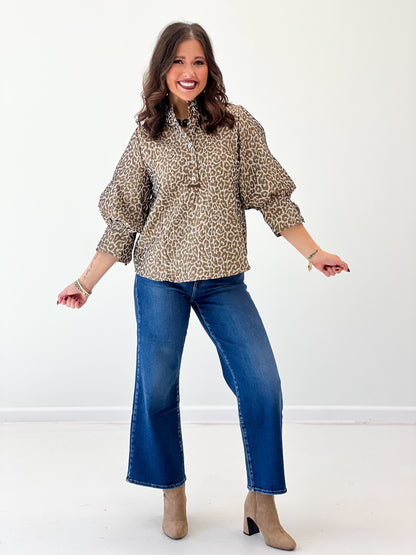 Taupe leopard jacquard button-up blouse with puff sleeves and tied cuff ties.