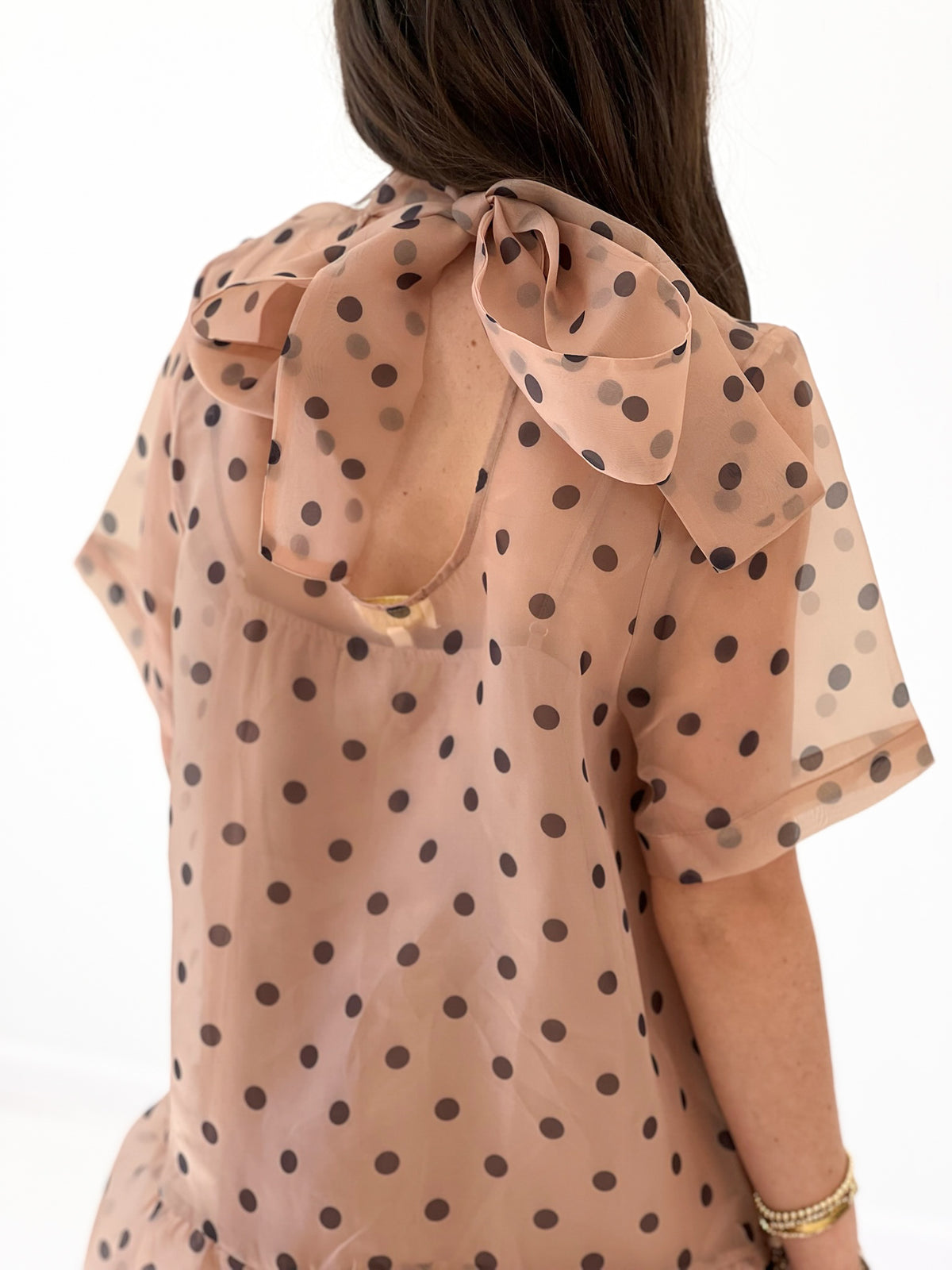 Ecru polka dot mini dress with back tie bow and sheer ruffle hem