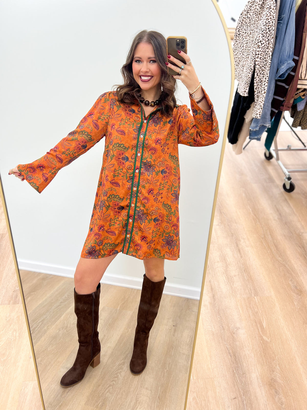 Orange floral bell-sleeve button dress with dark trim, long sleeves and short hem