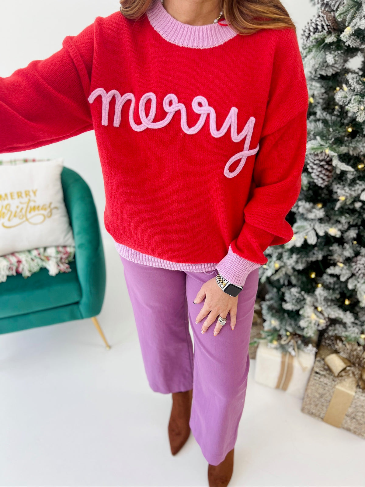 Red crewneck knit sweater with white "merry" script and ribbed hem