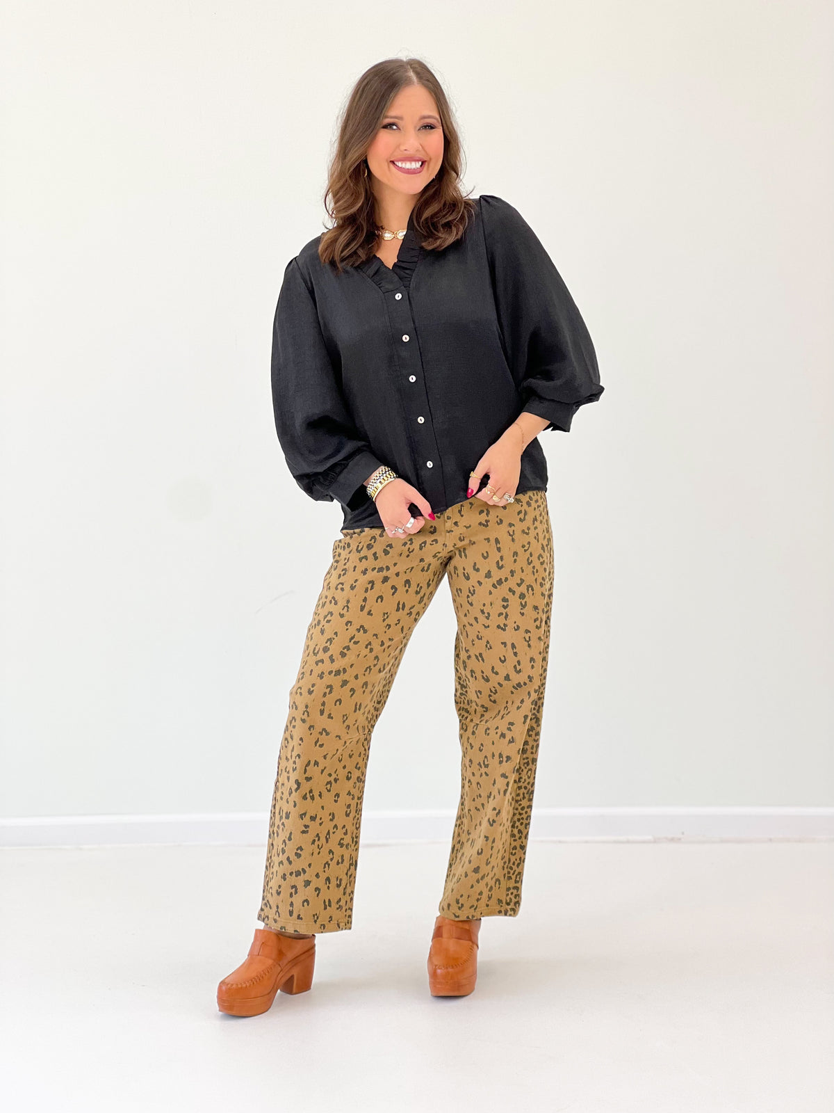 Black V-neck button-front blouse with long puff sleeves and button placket