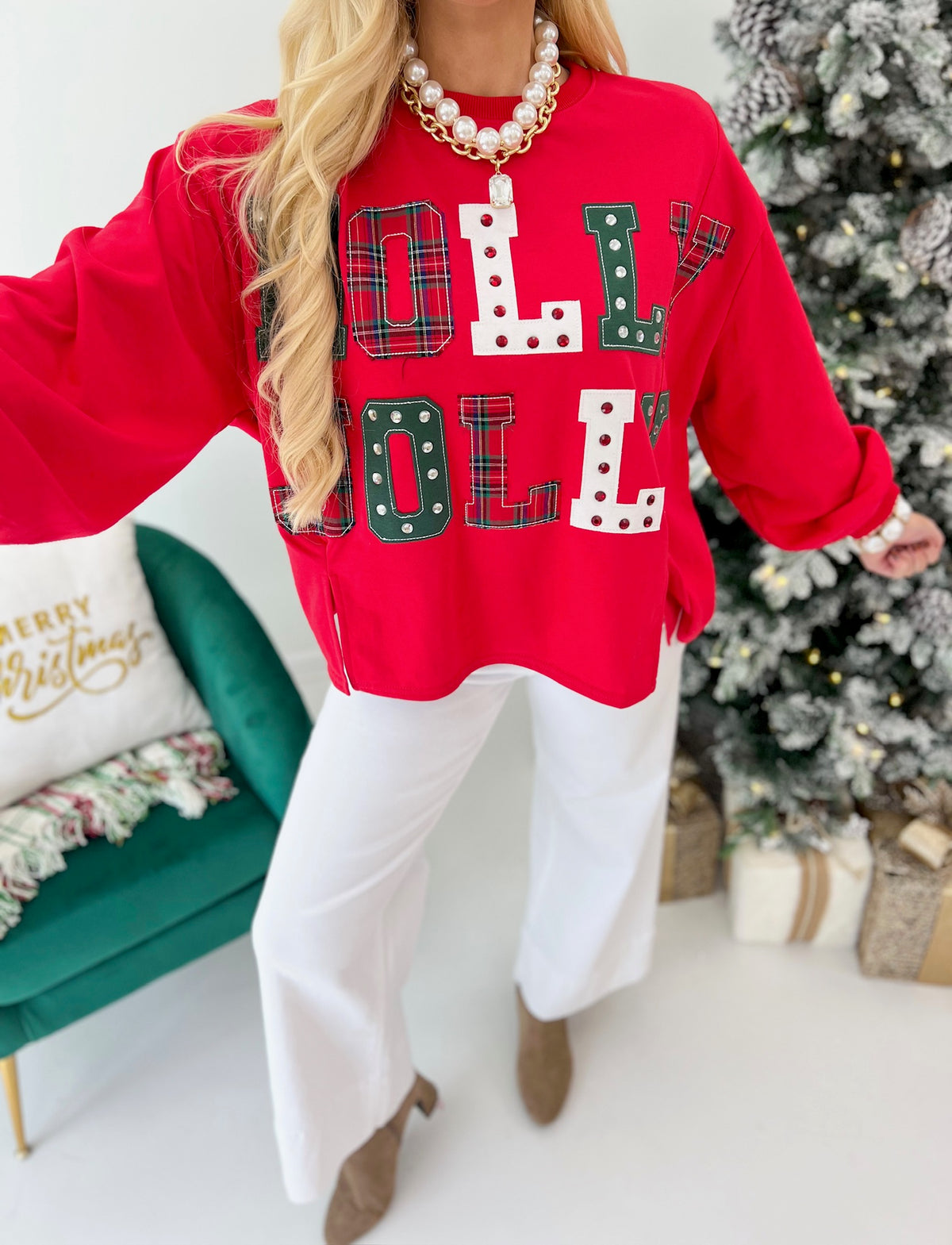 Red crewneck sweatshirt featuring colorful patchwork holiday letter graphic