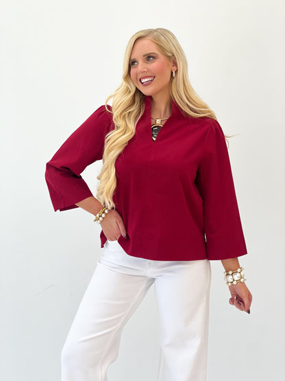 Burgundy textured V-neck blouse with wide sleeves and keyhole neckline