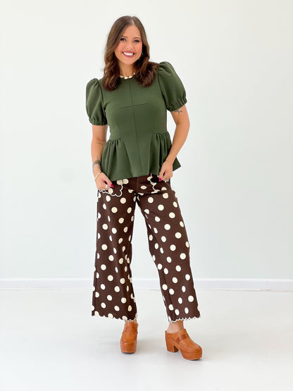 Olive green peplum hem knit top with puff sleeves and gathered peplum