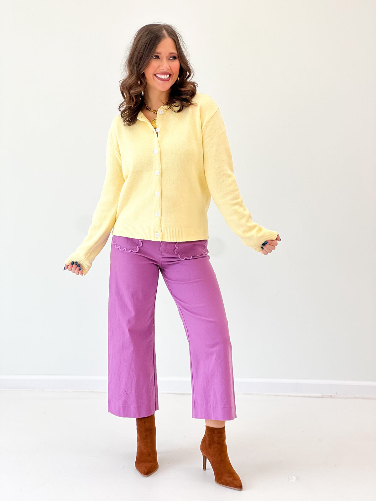 Yellow button-up cardigan with long sleeves and front buttons, knit style