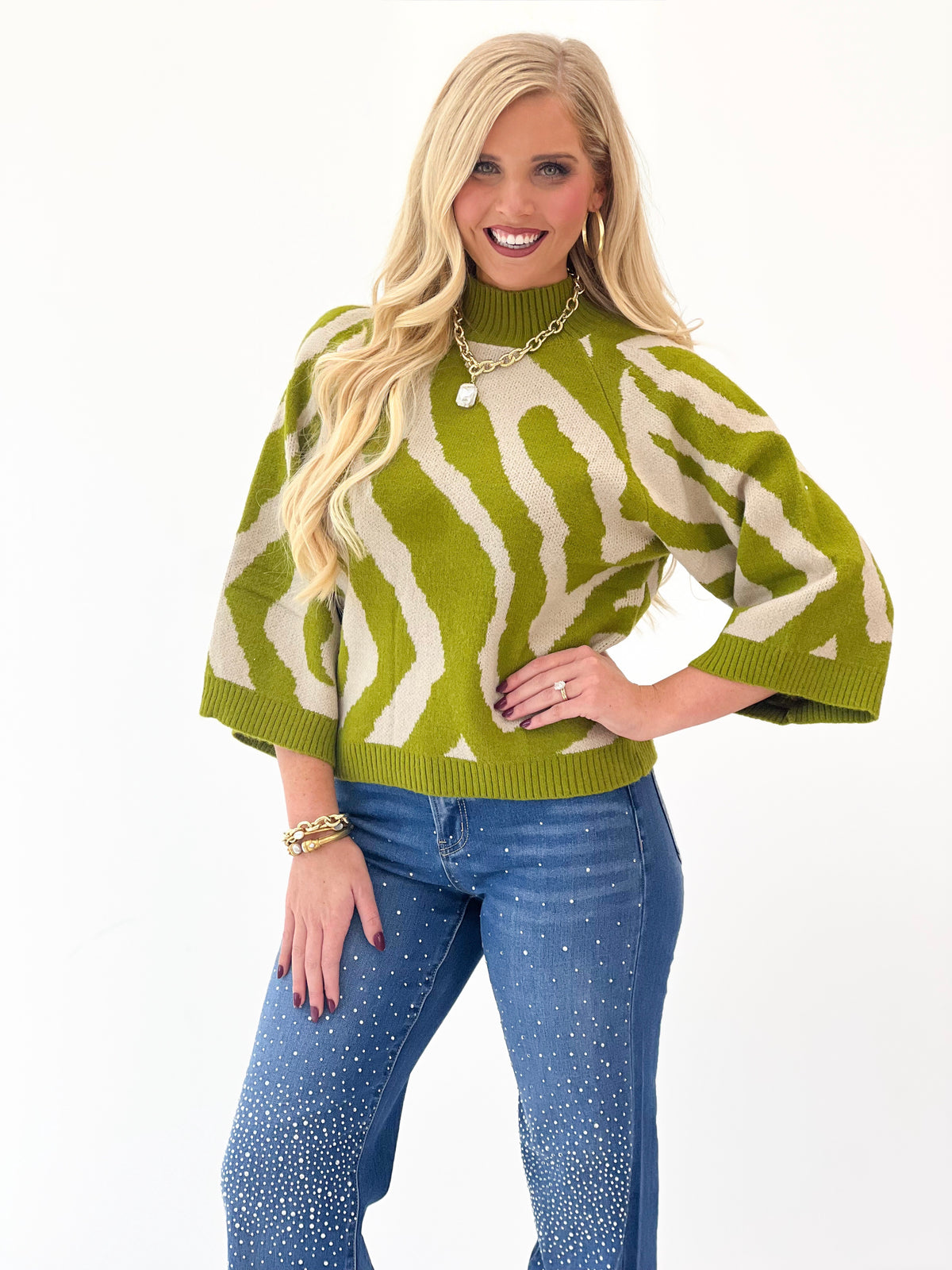 Olive abstract print knit sweater top with ribbed mock neck and wide sleeves