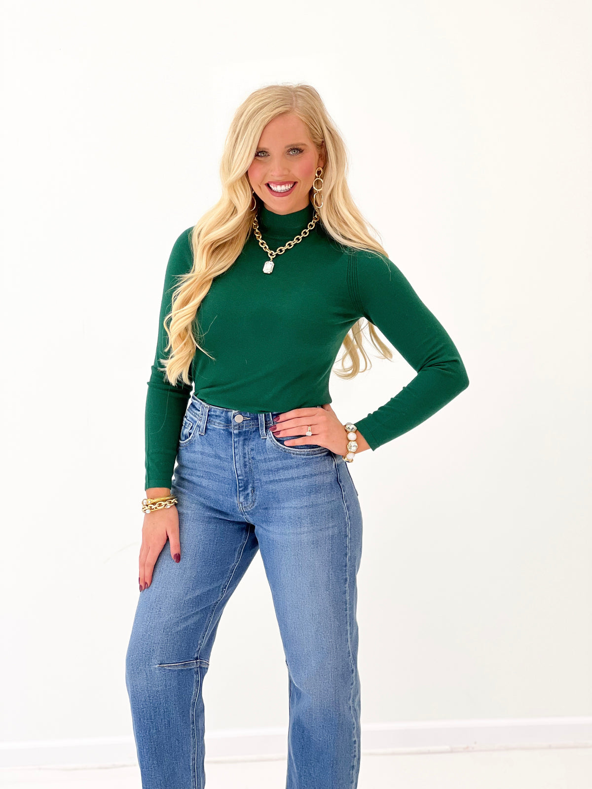 Green mockneck top with long sleeves and fitted silhouette