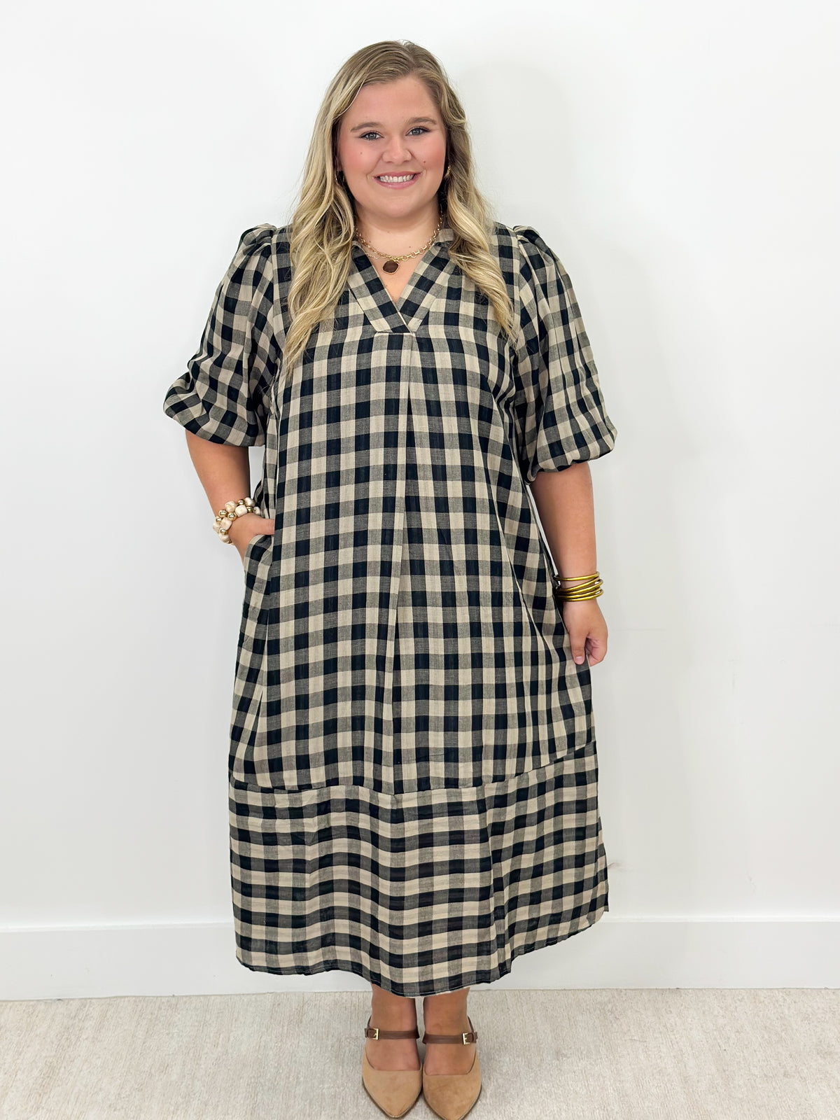 Navy and cream plaid midi dress with wide open collar and short sleeves, side view