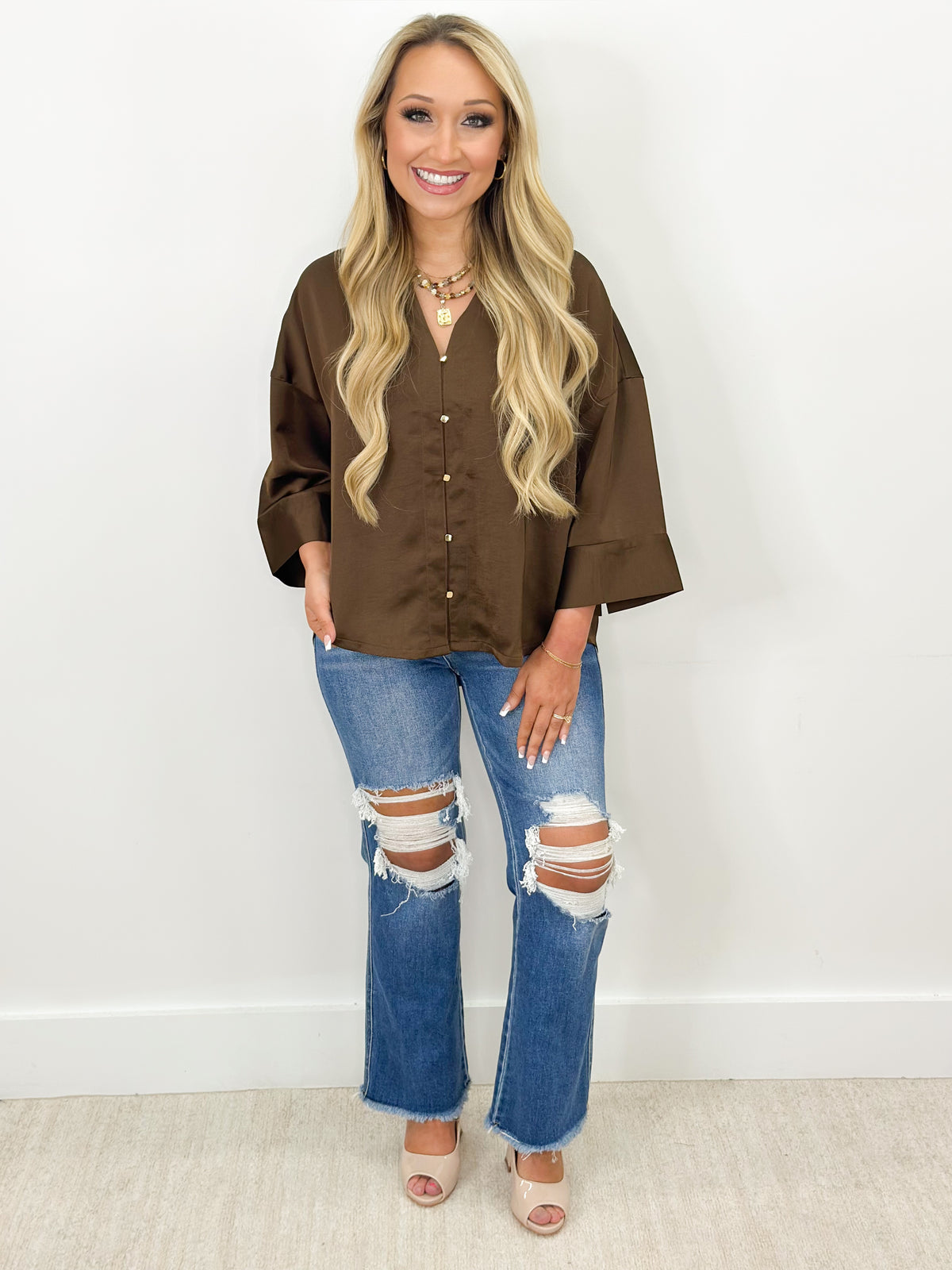 Brown V-neck button-down shirt with metal buttons and loose fit
