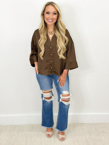 Brown V-neck button-down shirt with metal buttons and loose fit