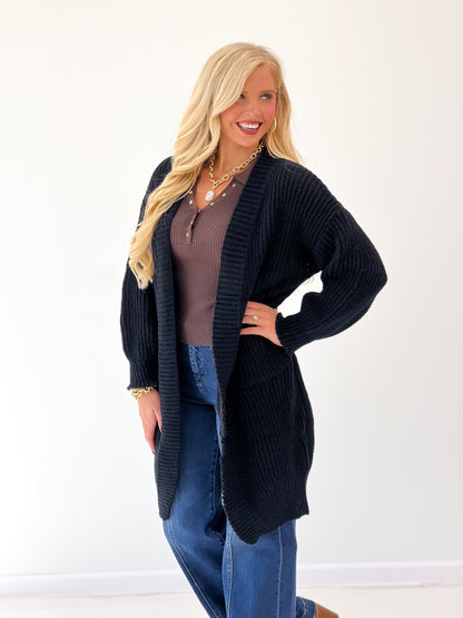 Black oversized loose-knit duster cardigan, long open front with side pockets