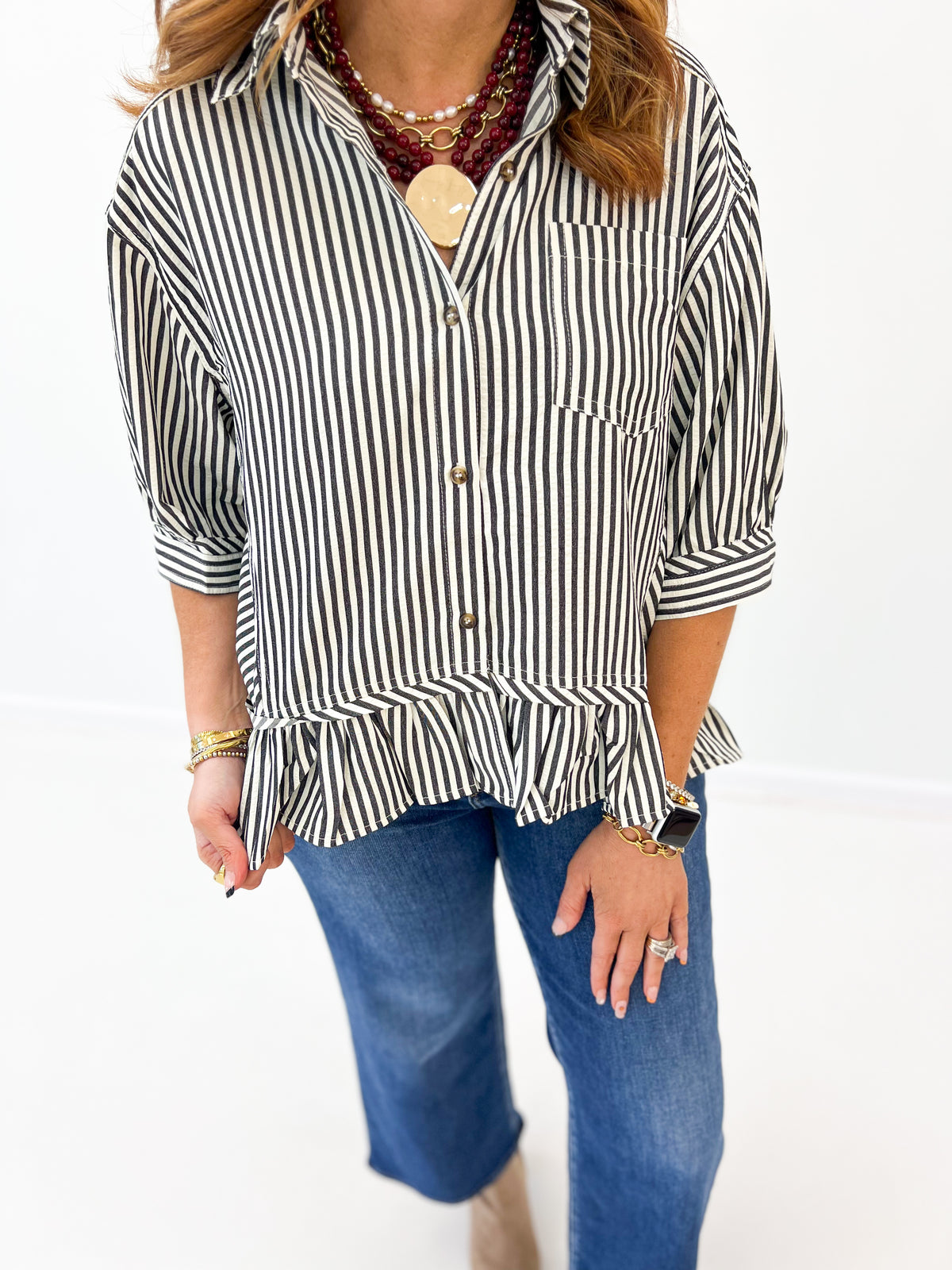 Black-and-white striped blouse close-up: chest pocket and button placket