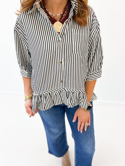 Black-and-white striped blouse close-up: chest pocket and button placket