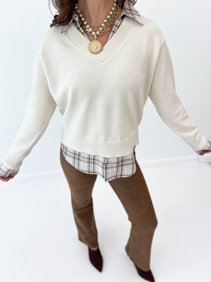 Cream layered sweater with V-neck, long sleeves, and plaid collared hem