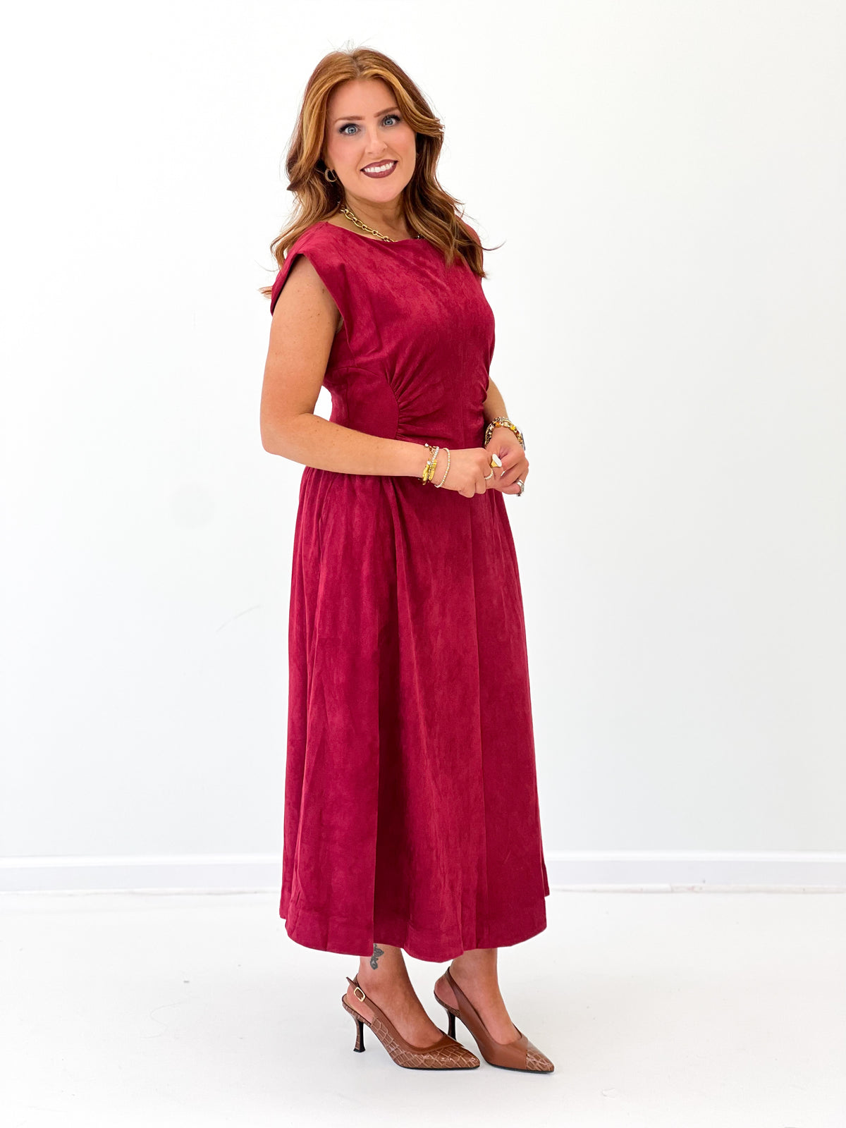Burgundy faux suede midi dress with sleeveless cut and smooth fitted bodice