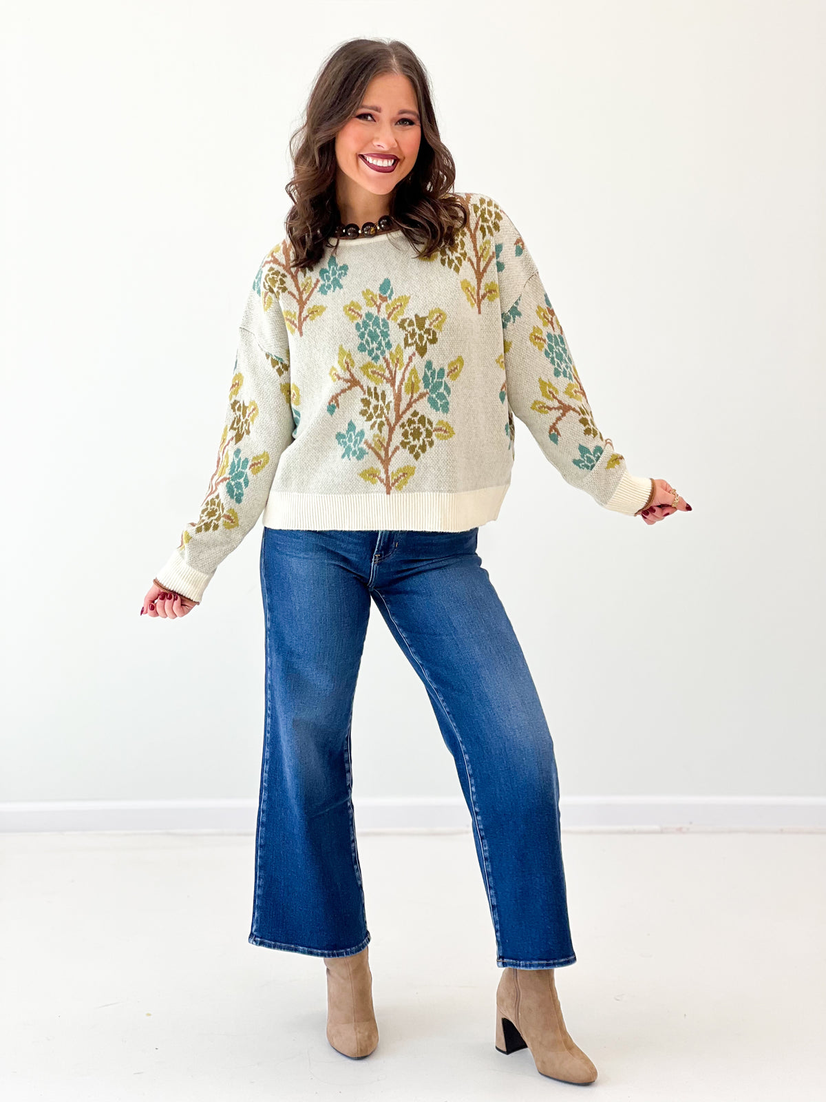 Cream knit tree-printed sweater top with crew neck, long sleeves, ribbed cuffs