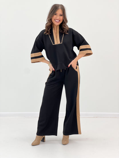 Black zip-up sweatshirt and wide-leg pants with tan contrast front and sleeve stripe