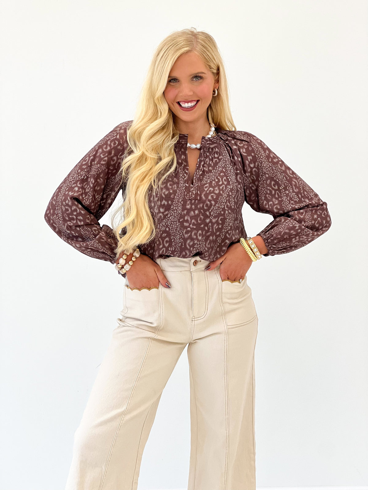 Brown printed V-neck long-sleeve top with full-length sleeves and patterned fabric