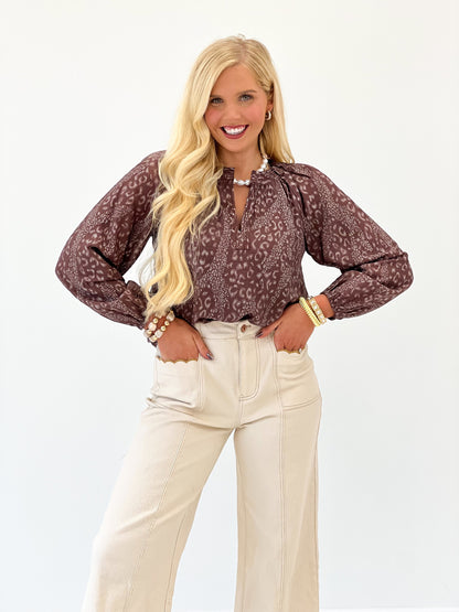 Brown printed V-neck long-sleeve top with full-length sleeves and patterned fabric
