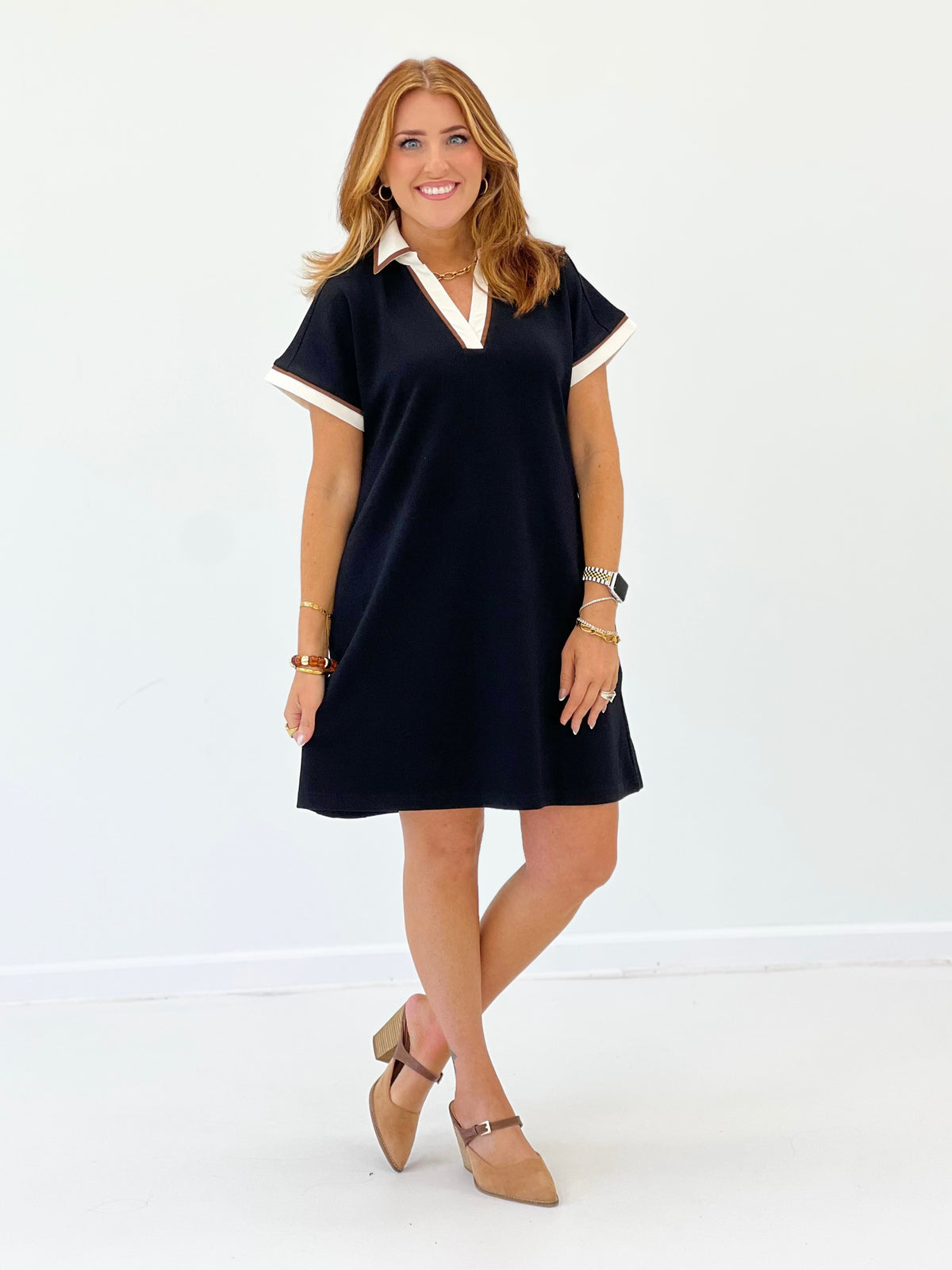 V-neck collared dress with white-trim collar, short sleeves, dark color, full length