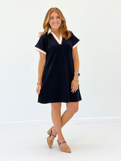 V-neck collared dress with white-trim collar, short sleeves, dark color, full length