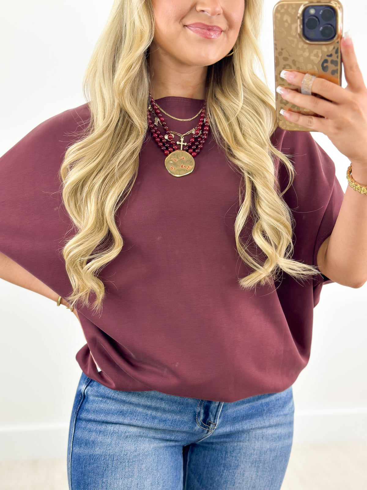 Wine short sleeve scuba dolman top with crew neckline and draped relaxed fit