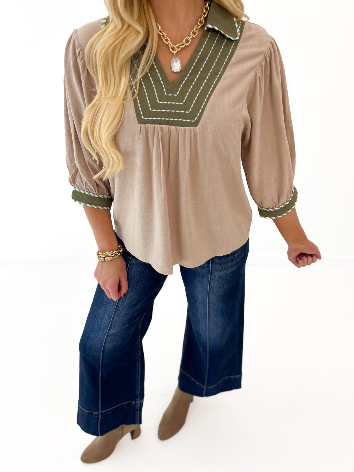 Stone linen blouse with green V-neck trim, short puff sleeves, gathered cuffs